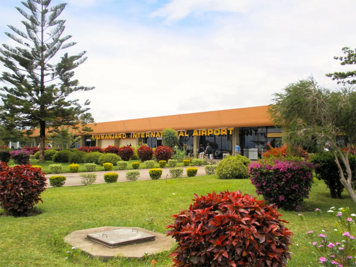 Eingang des Kilimanjaro International Airport hinter einem Blumenbeet