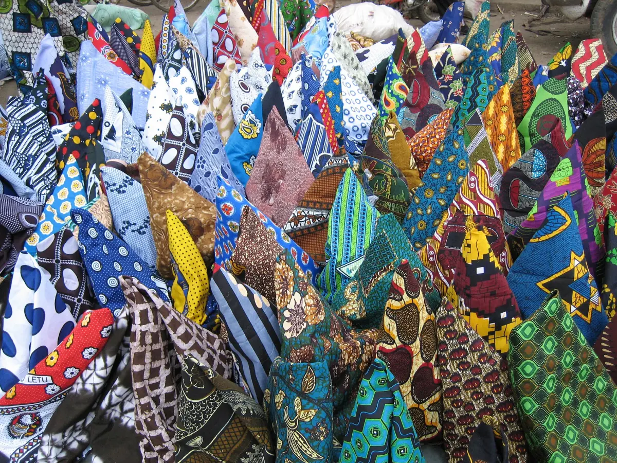 Bunte Kitenge- und Kanga-Stoffe, gestapelt an einem Marktstand
